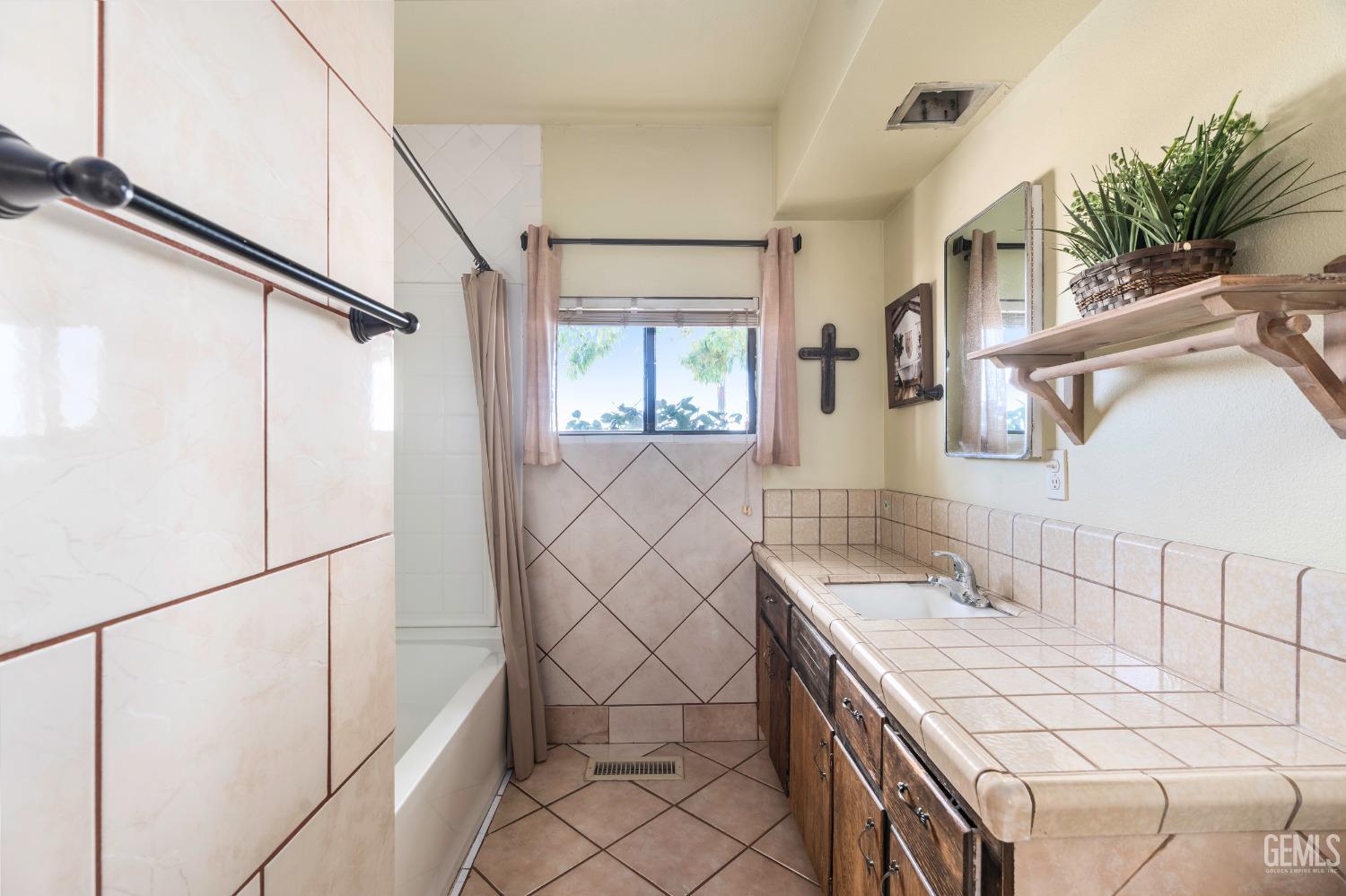 Undisclosed Address Delano, CA 93215 - Photo 24 of 72 a bathroom with a sink and mirror with bathtub
