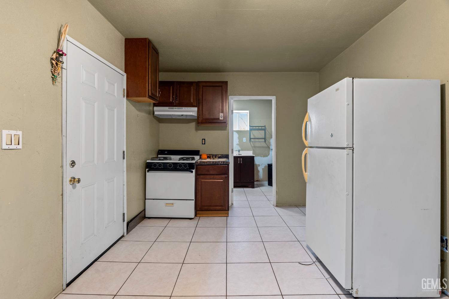 Undisclosed Address Delano, CA 93215 - Photo 27 of 72 a kitchen with stainless steel appliances a refrigerator sink and cabinets