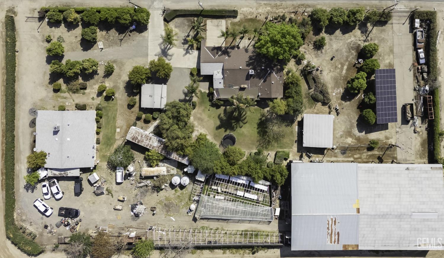Undisclosed Address Delano, CA 93215 - Photo 3 of 72 an aerial view of a house with a yard and large trees