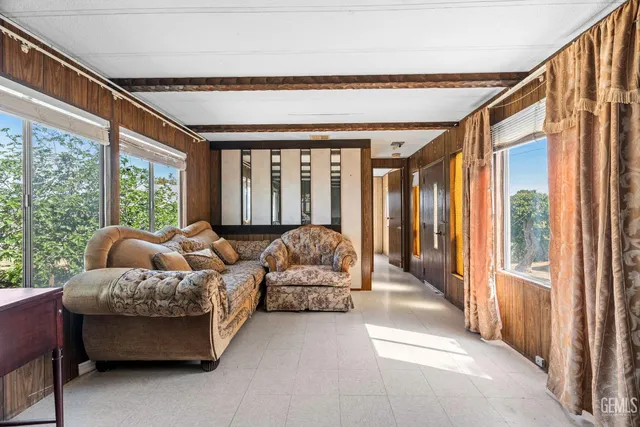 a view of a livingroom with an empty space and a ceiling fan