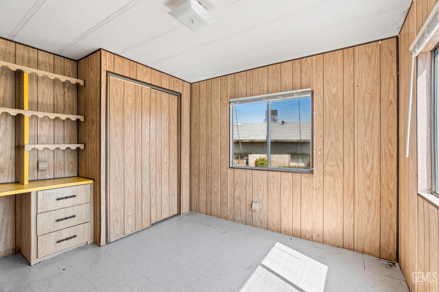 Undisclosed Address Delano, CA 93215 - Photo 37 of 72 a view of an empty room with cabinet and a window