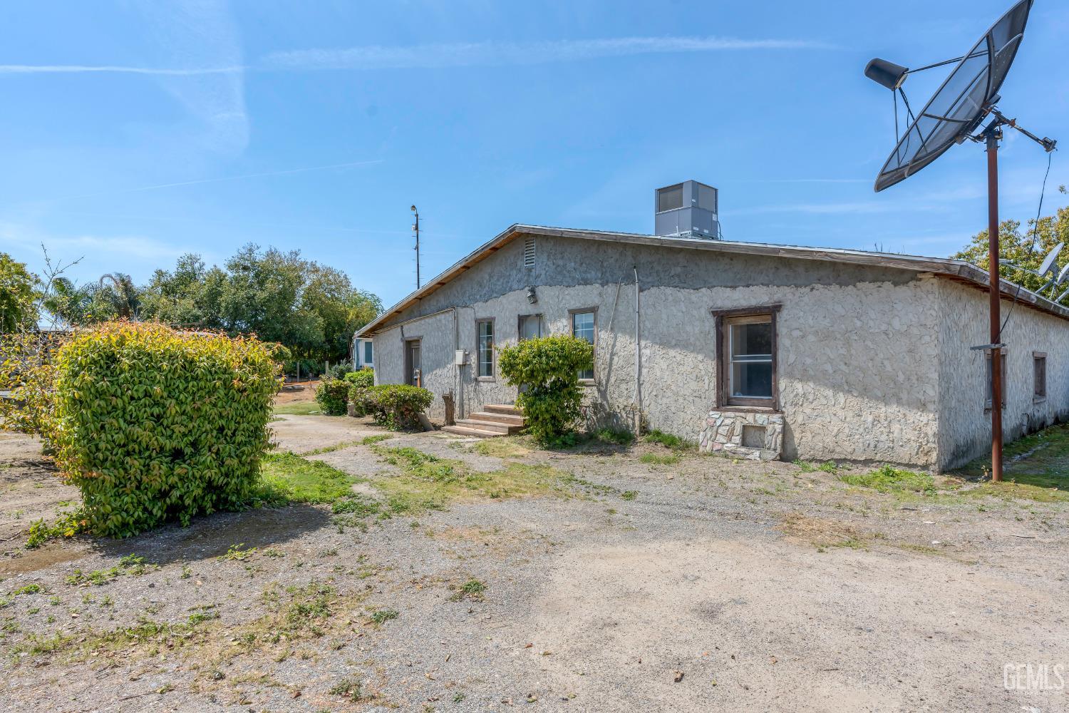 Undisclosed Address Delano, CA 93215 - Photo 38 of 72 a front view of a house with a yard and garage