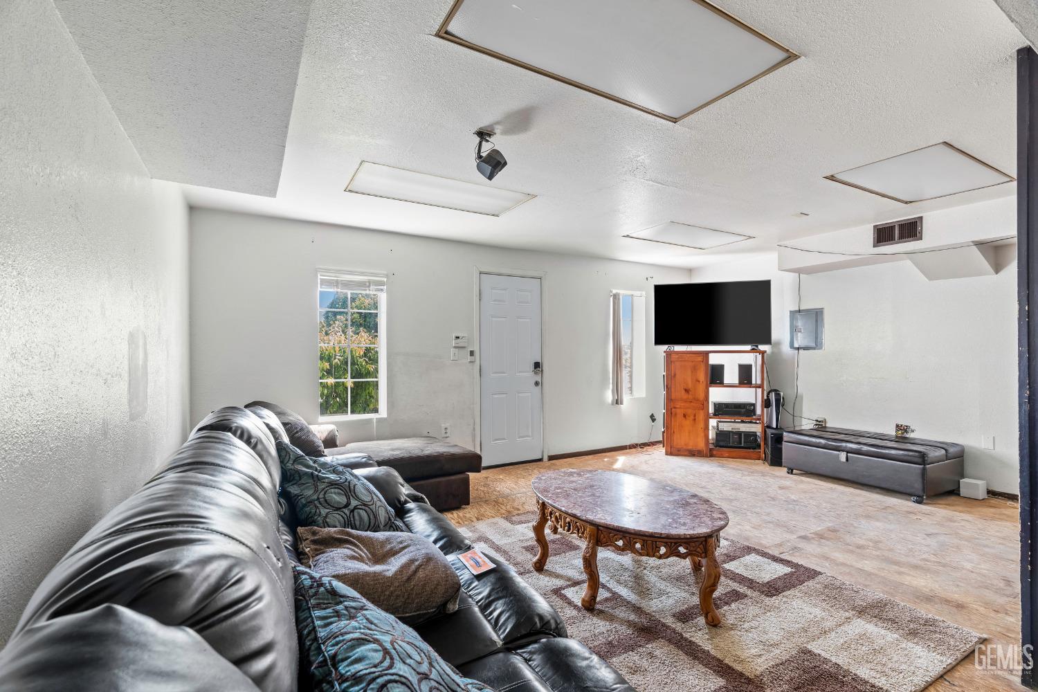 Undisclosed Address Delano, CA 93215 - Photo 41 of 72 a living room with furniture and a flat screen tv