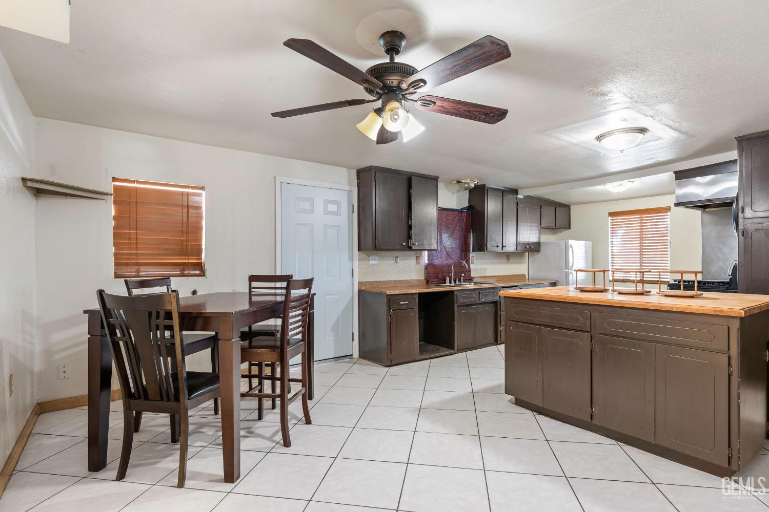 Undisclosed Address Delano, CA 93215 - Photo 49 of 72 a kitchen with stainless steel appliances granite countertop a sink a stove a dining table and chairs