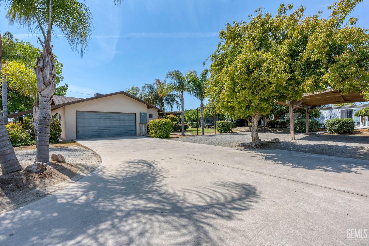 Undisclosed Address Delano, CA 93215 - Photo 51 of 72 a front view of a house with a yard and garage