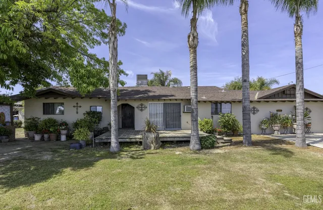 a view of a house with a tree in front of it