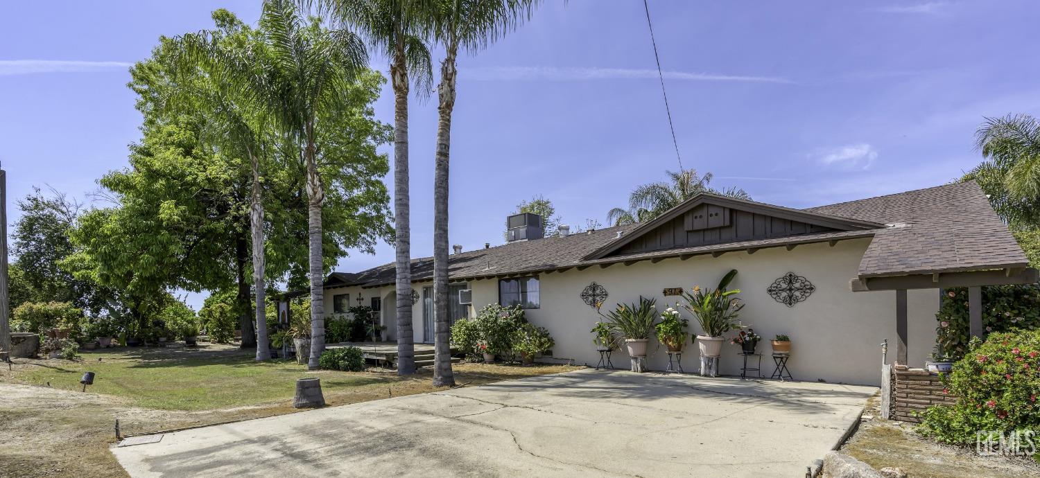 Undisclosed Address Delano, CA 93215 - Photo 7 of 72 a front view of a house with garden