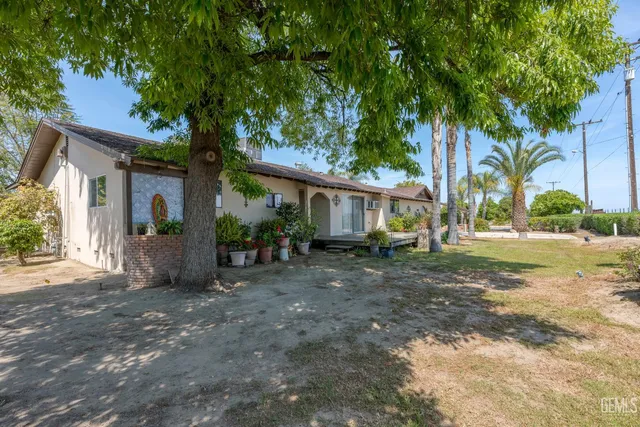 a living room with furniture and a dining table