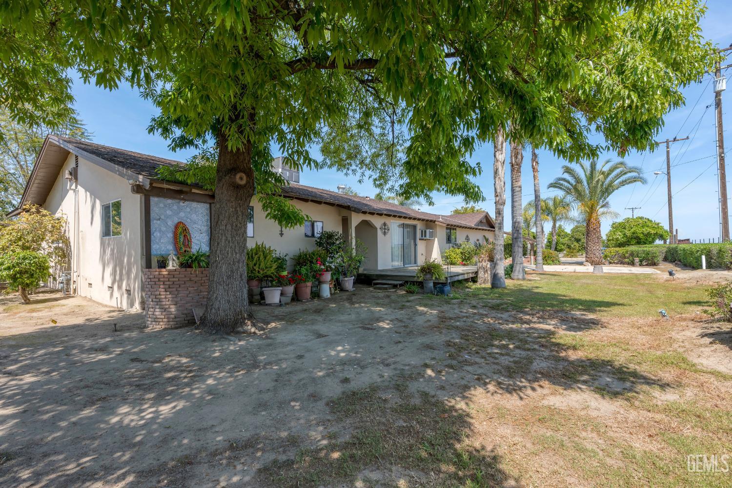 Undisclosed Address Delano, CA 93215 - Photo 9 of 72 a view of a house with a tree in front of it