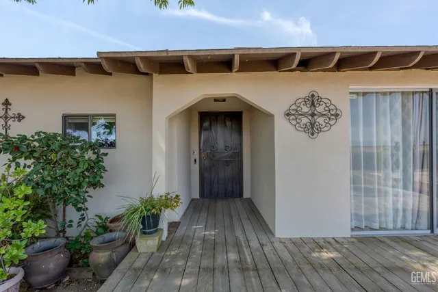 a kitchen with granite countertop a sink cabinets and stainless steel appliances