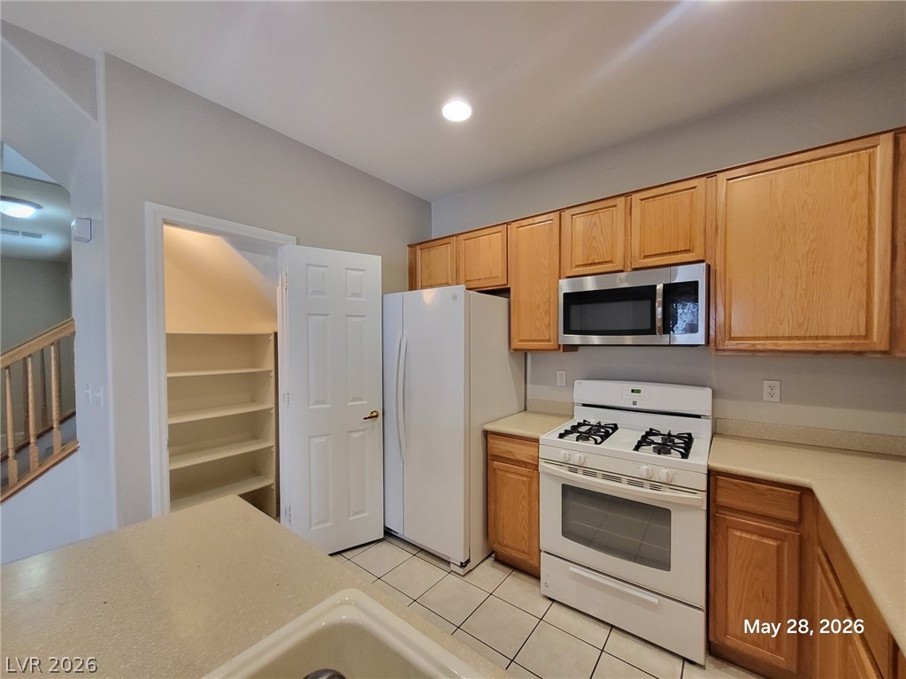 9843 West Overlook Ridge Avenue Las Vegas, NV 89148 - Photo 4 of 19 A well-appointed kitchen features ample cabinetry, modern appliances, and convenient pantry storage.