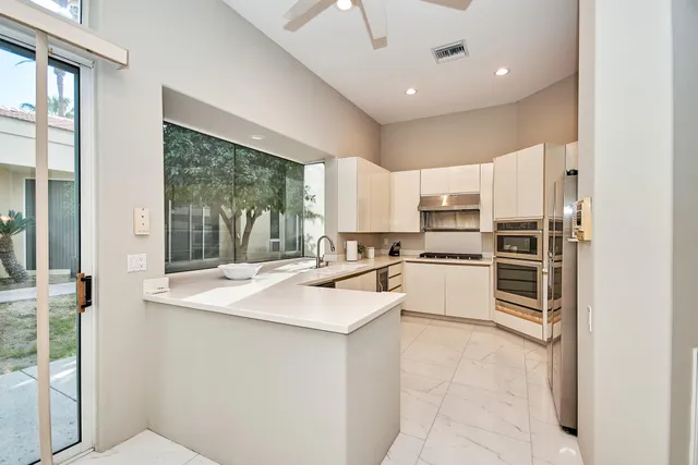 a kitchen with a sink stove and refrigerator