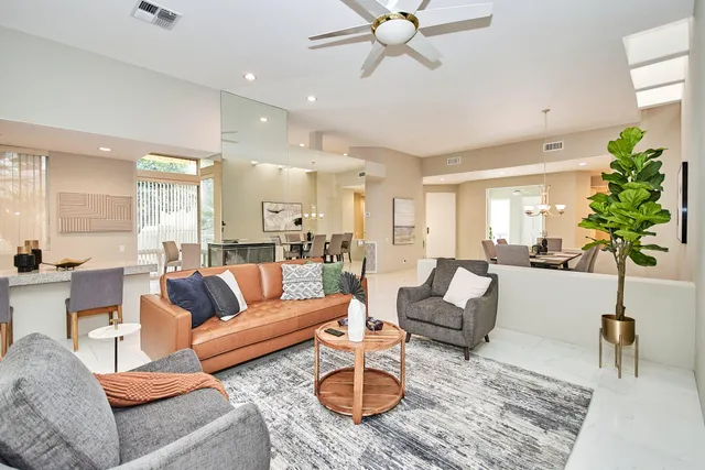 a living room with furniture potted plant and a lamp