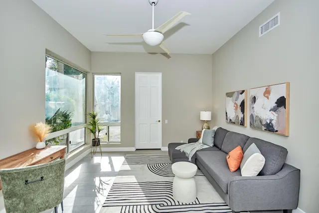 a living room with furniture and a large window