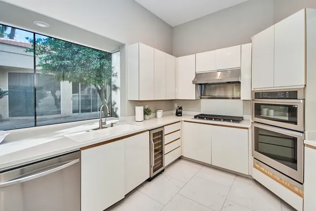 a kitchen with a sink stove and cabinets