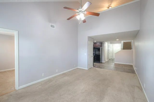 a view of livingroom and chandelier fan