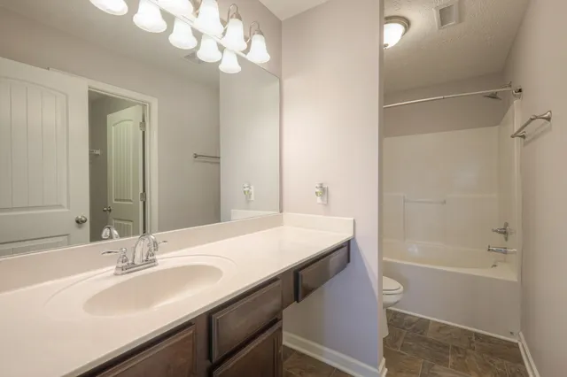 an empty room with a ceiling fan and a window