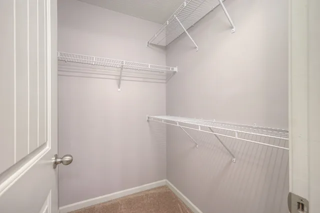 a view of a hallway with wooden floor and entryway