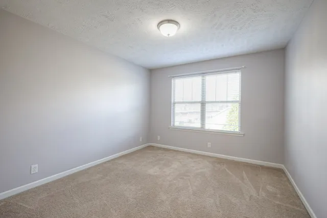 an empty room with closet and a bathroom