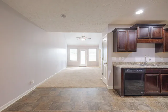 a kitchen with granite countertop stainless steel appliances and wooden cabinets