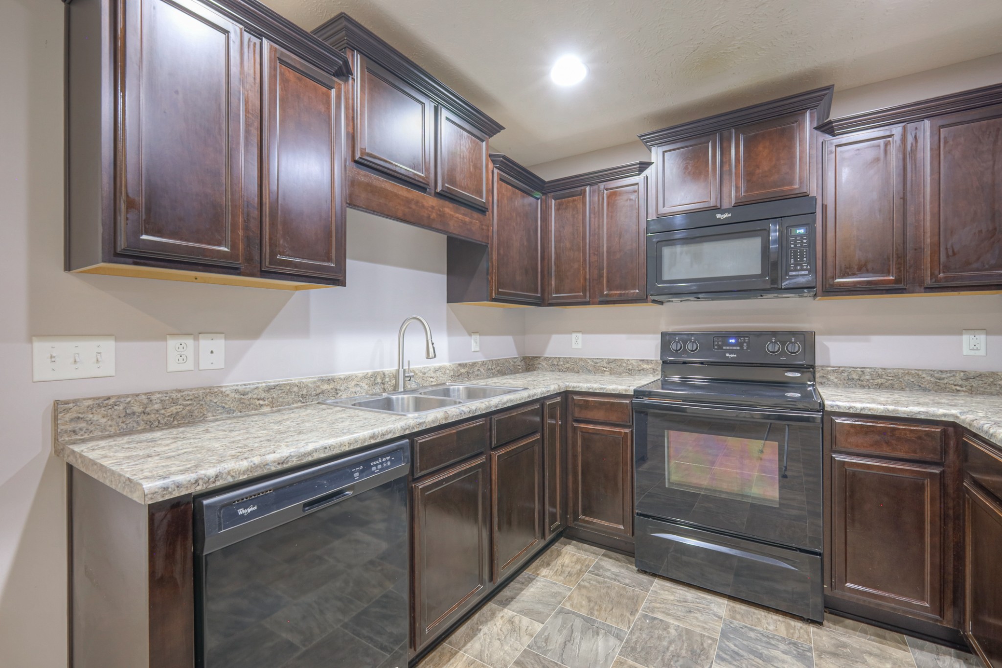 4245 Sunday Silence Way Murfreesboro, TN 37128 - Photo 8 of 39 a kitchen with granite countertop stainless steel appliances and wooden cabinets