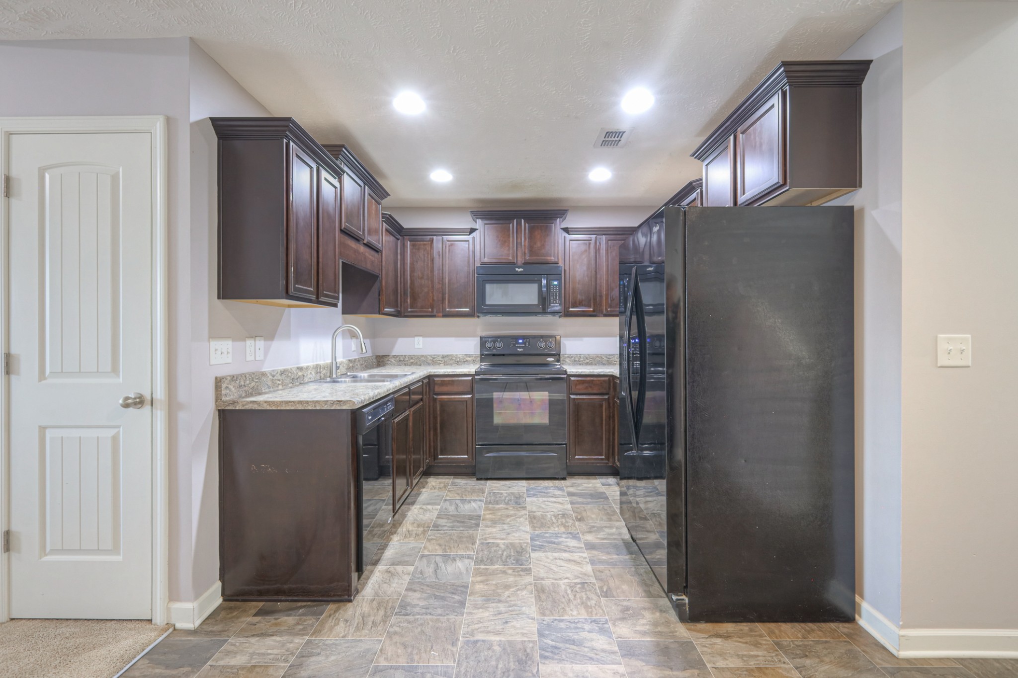 4245 Sunday Silence Way Murfreesboro, TN 37128 - Photo 10 of 39 a kitchen with stainless steel appliances granite countertop a refrigerator and a stove top oven