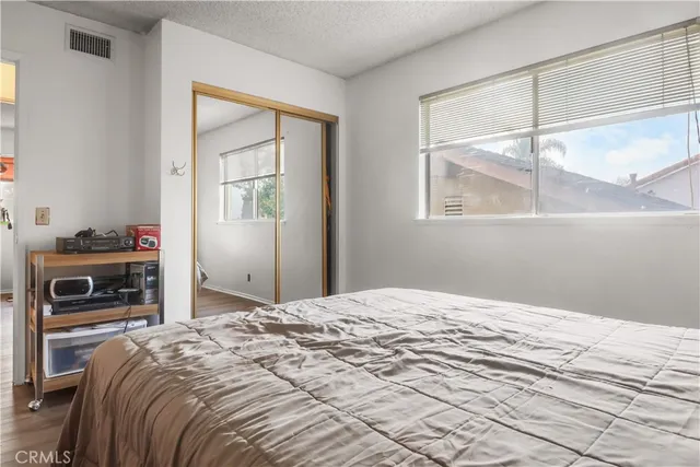 a bedroom with a bed and a window