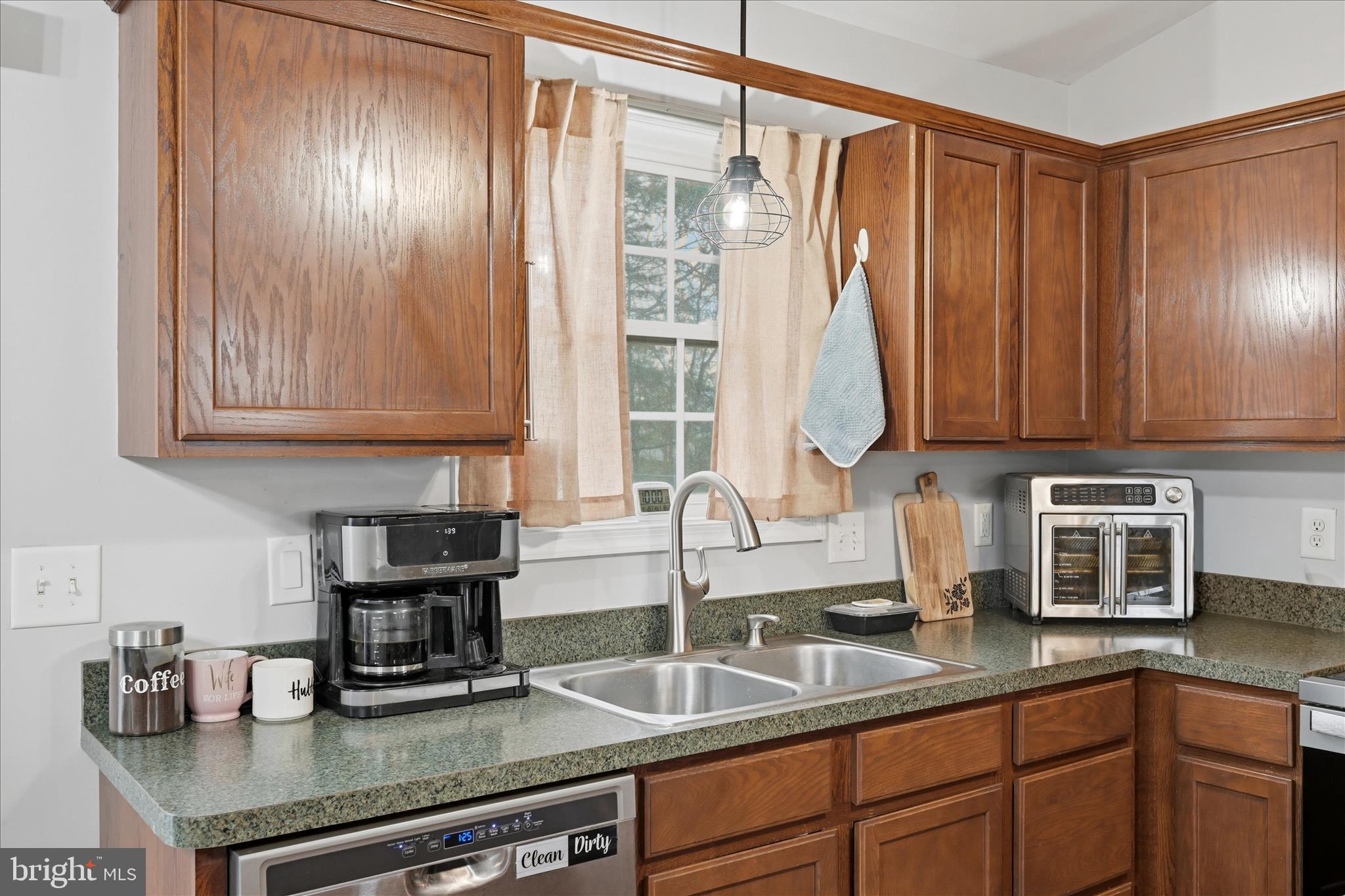 212 Freight Car Circle Inwood, WV 25428 - Photo 11 of 41 a kitchen with granite countertop a sink a counter space and cabinets