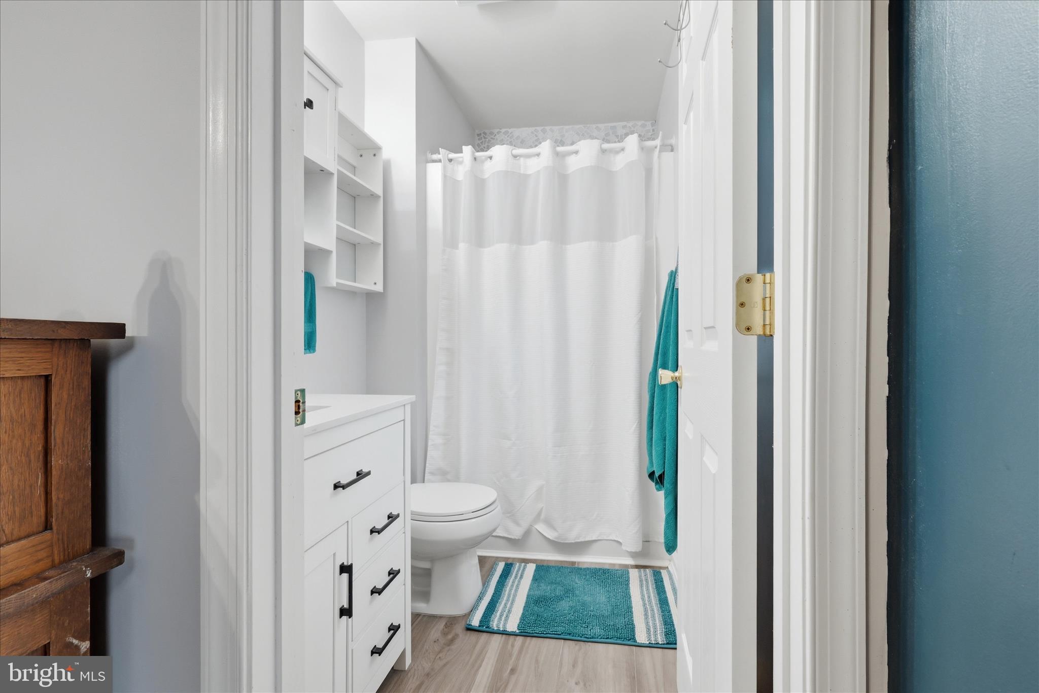 212 Freight Car Circle Inwood, WV 25428 - Photo 17 of 41 a view of bathroom with a shower curtain and a sink