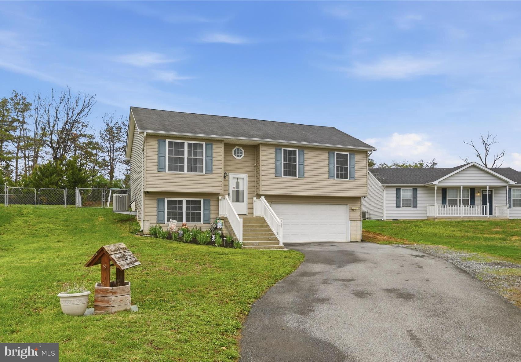212 Freight Car Circle Inwood, WV 25428 - Photo 3 of 41 a front view of a house with a yard and trees