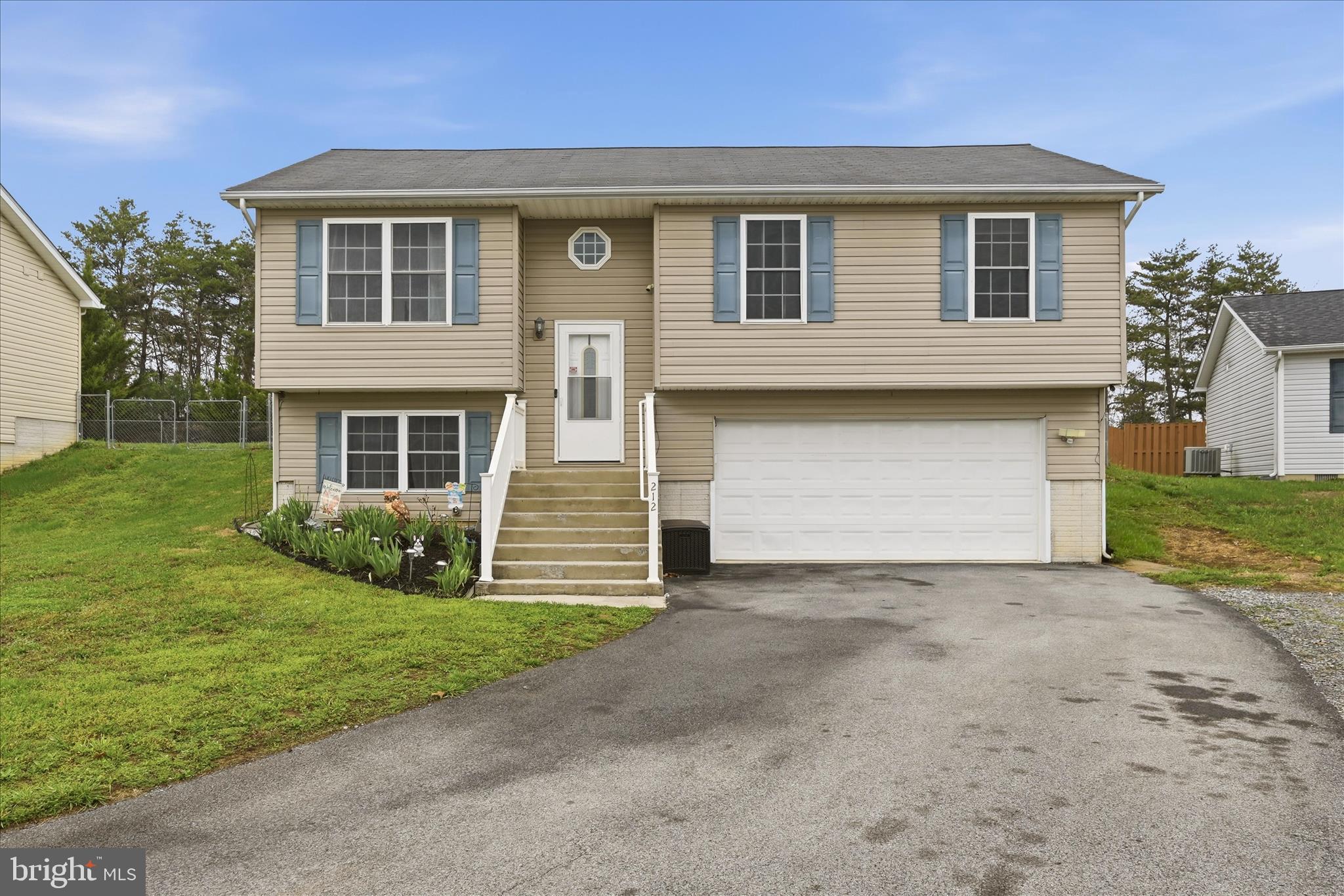 212 Freight Car Circle Inwood, WV 25428 - Photo 31 of 41 a front view of a house with a yard and garage