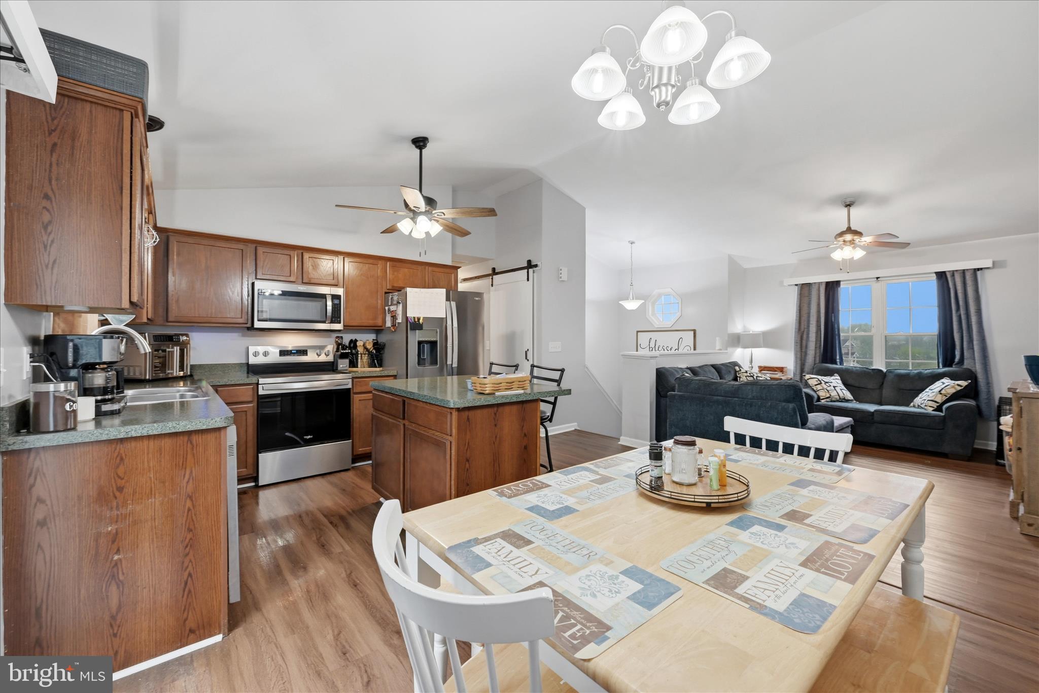 212 Freight Car Circle Inwood, WV 25428 - Photo 8 of 41 a kitchen with stainless steel appliances kitchen island granite countertop a sink dishwasher a stove a refrigerator with a dining table and chairs