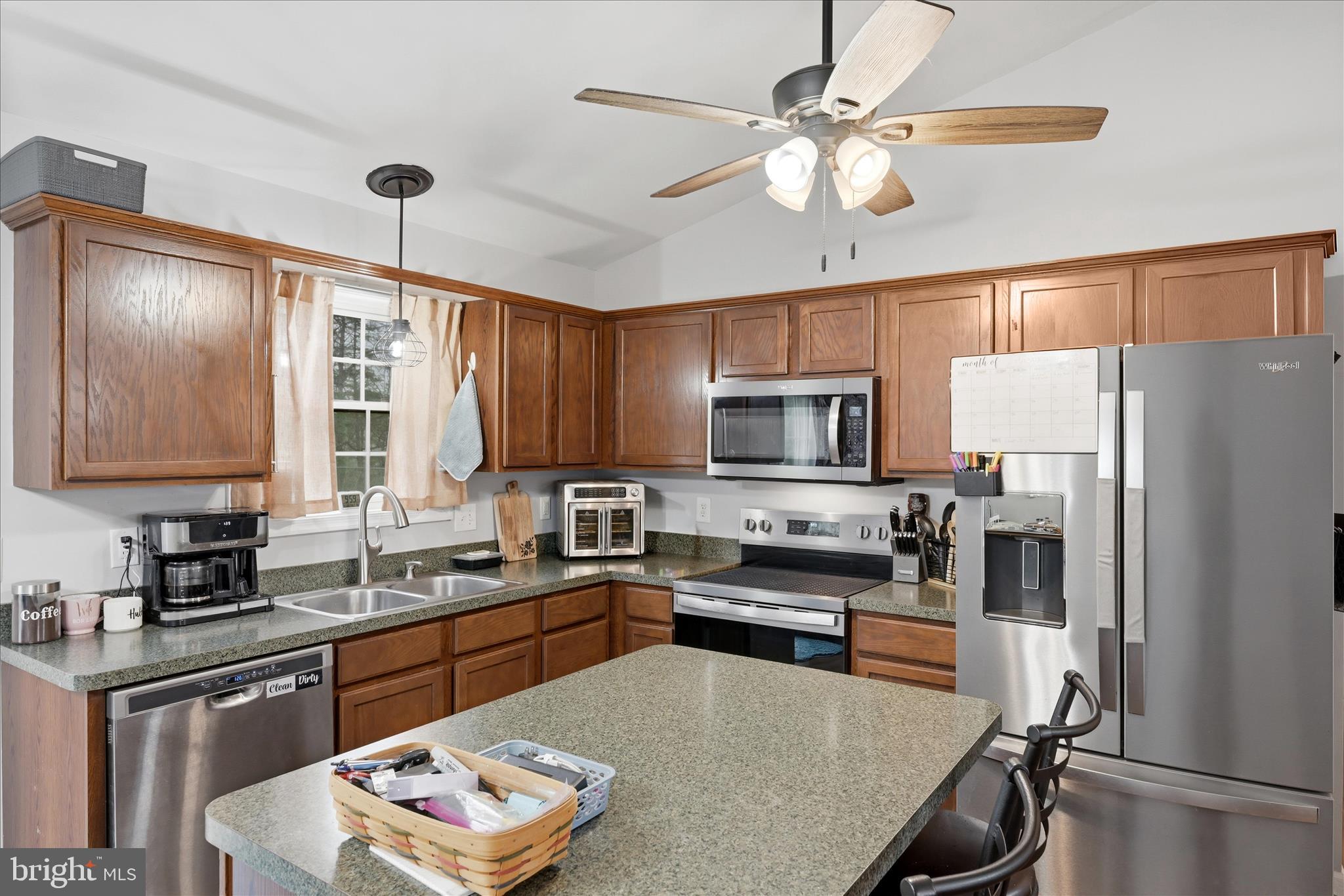 212 Freight Car Circle Inwood, WV 25428 - Photo 9 of 41 a kitchen with stainless steel appliances granite countertop a refrigerator a sink dishwasher a stove and white countertops with wooden floor