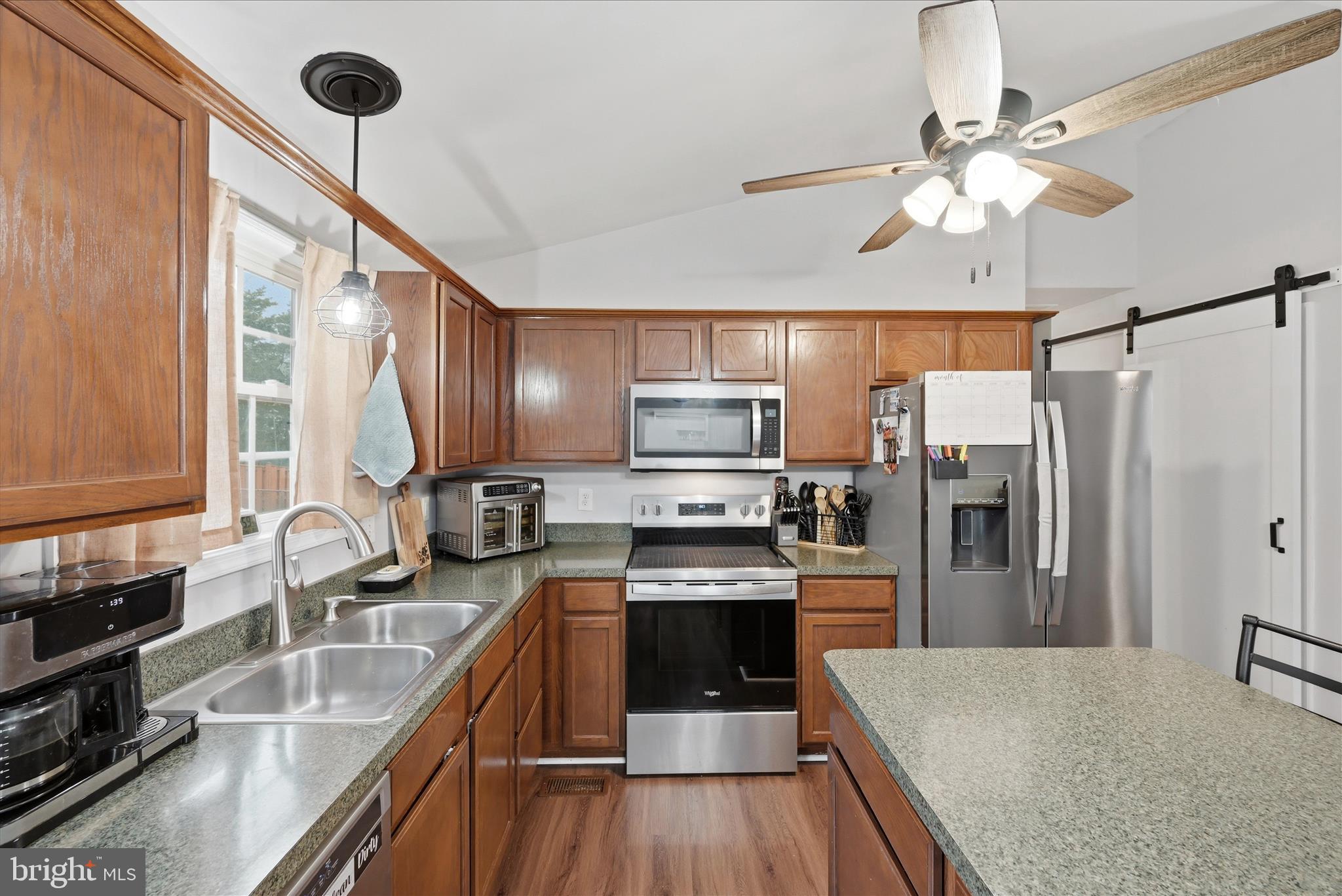 212 Freight Car Circle Inwood, WV 25428 - Photo 10 of 41 a kitchen with kitchen island granite countertop a sink appliances cabinets and counter space