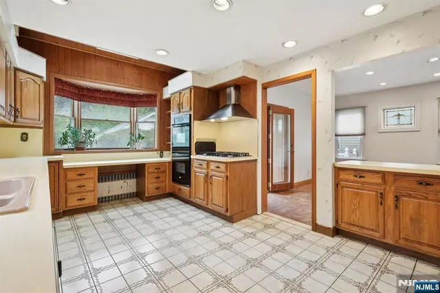 a kitchen with stainless steel appliances a sink and a refrigerator