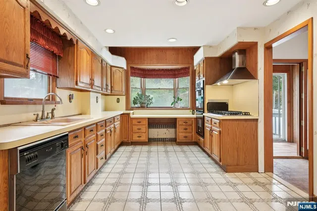 a kitchen with stainless steel appliances a sink and cabinets