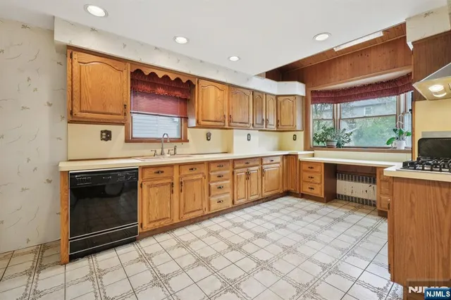 a kitchen with a stove sink and cabinets