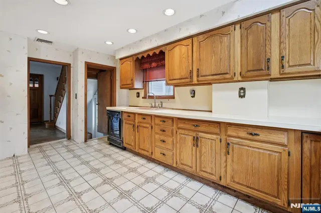 a kitchen with stainless steel appliances granite countertop a refrigerator and cabinets