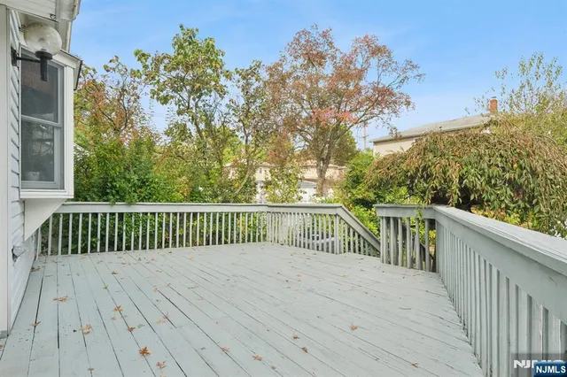 a balcony with wooden floor and fence