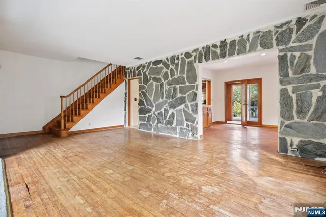 a view of an entryway with wooden floor