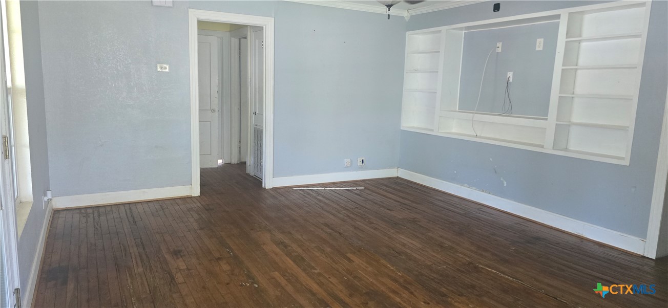 2001 East Forrest Street Victoria, TX 77901 - Photo 4 of 16 a view of an empty room with wooden floor and a window