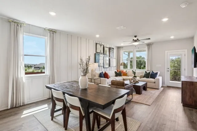 a living room with furniture potted plant and windows