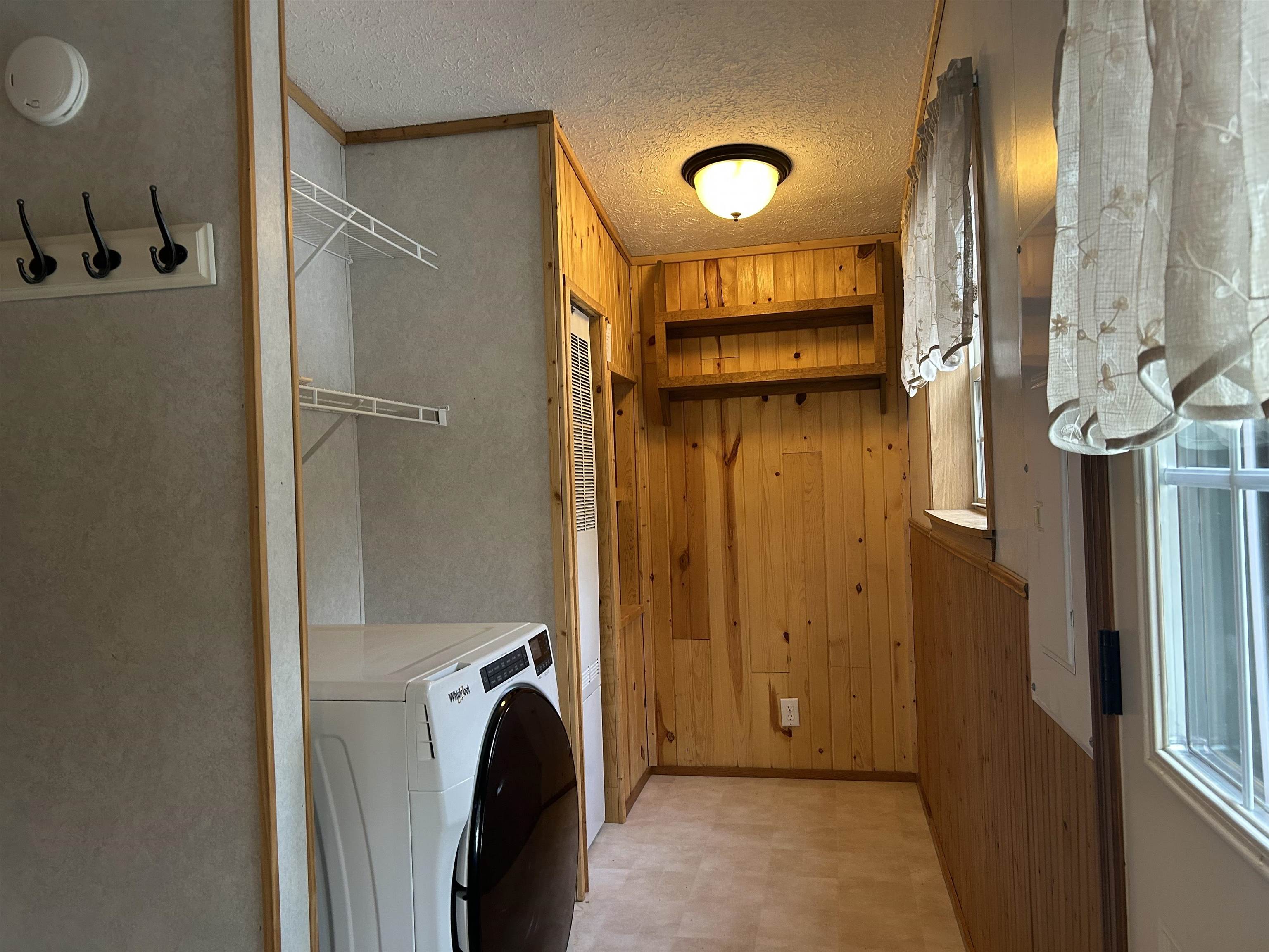 1302 Old North Shore Road Duluth, MN 55804 - Photo 44 of 75 Washroom featuring light flooring, wood walls, washer / dryer, and a textured ceiling