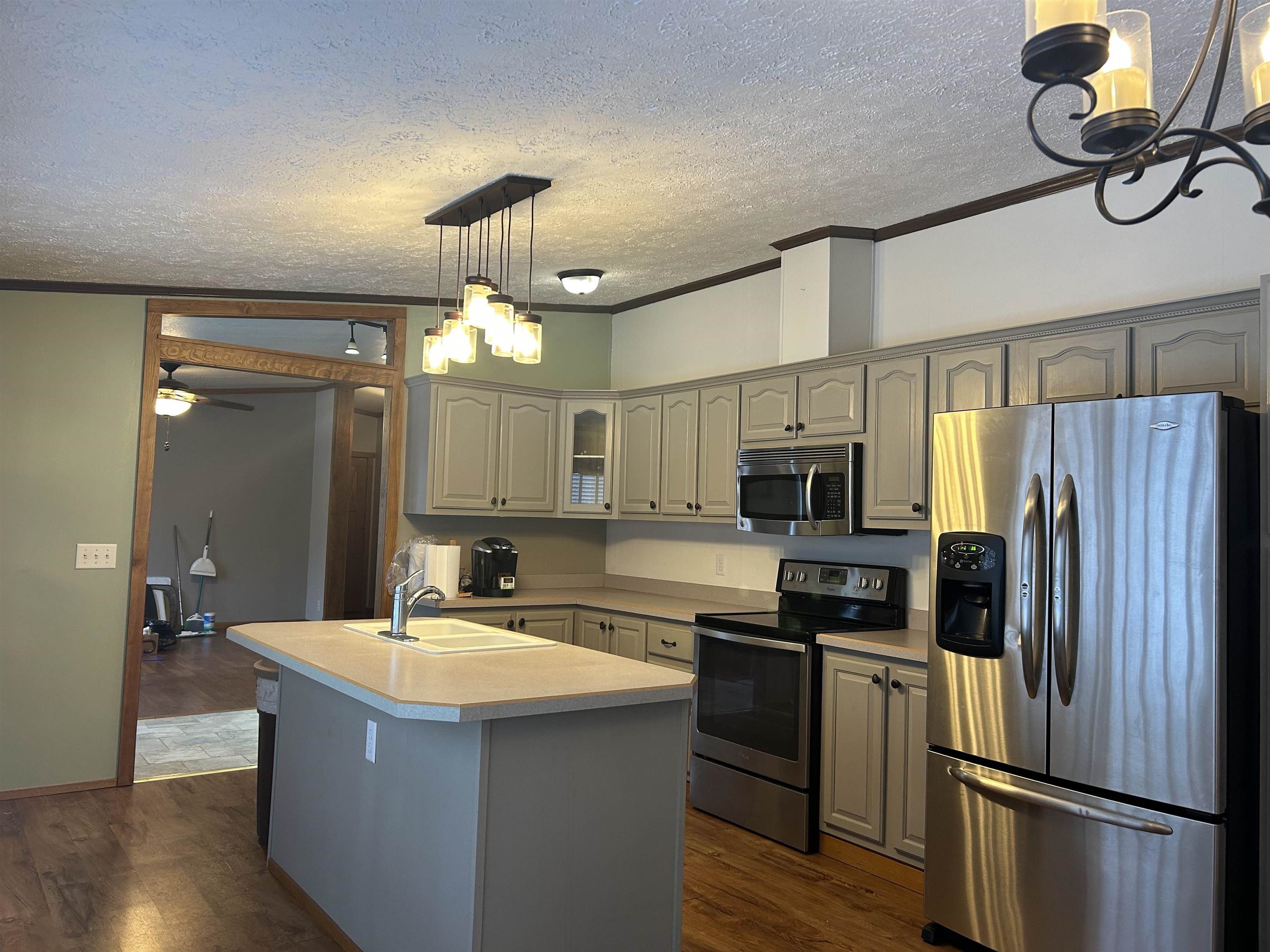1302 Old North Shore Road Duluth, MN 55804 - Photo 45 of 75 Kitchen featuring a chandelier, appliances with stainless steel finishes, decorative light fixtures, light countertops, and a textured ceiling