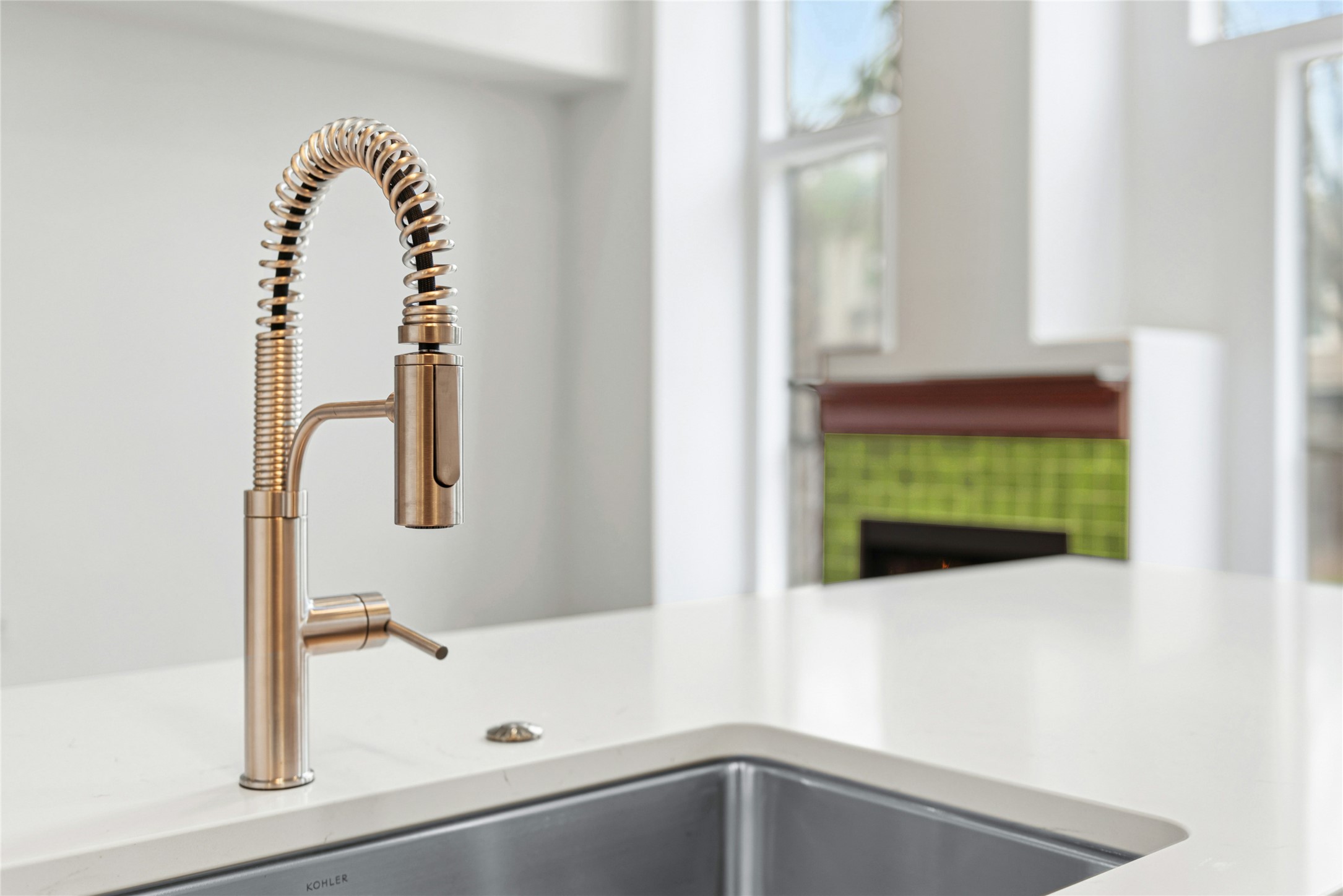 813 Caribou Ridge Trail Pflugerville, TX 78660 - Photo 16 of 39 Modern stainless steel spring kitchen faucet paired with quartz countertops and a deep undermount sink.