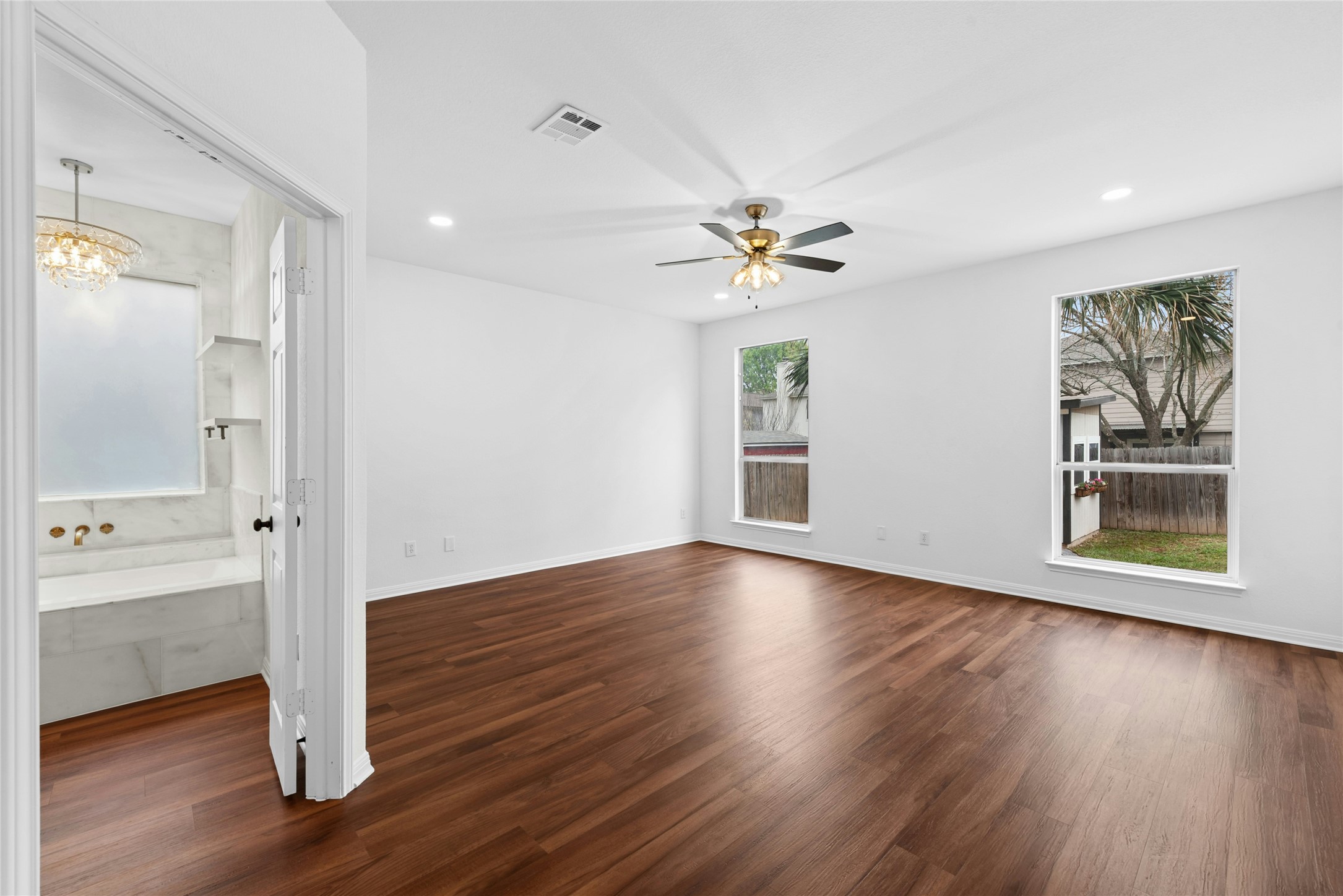 813 Caribou Ridge Trail Pflugerville, TX 78660 - Photo 18 of 39 a view of an empty room with wooden floor and a window