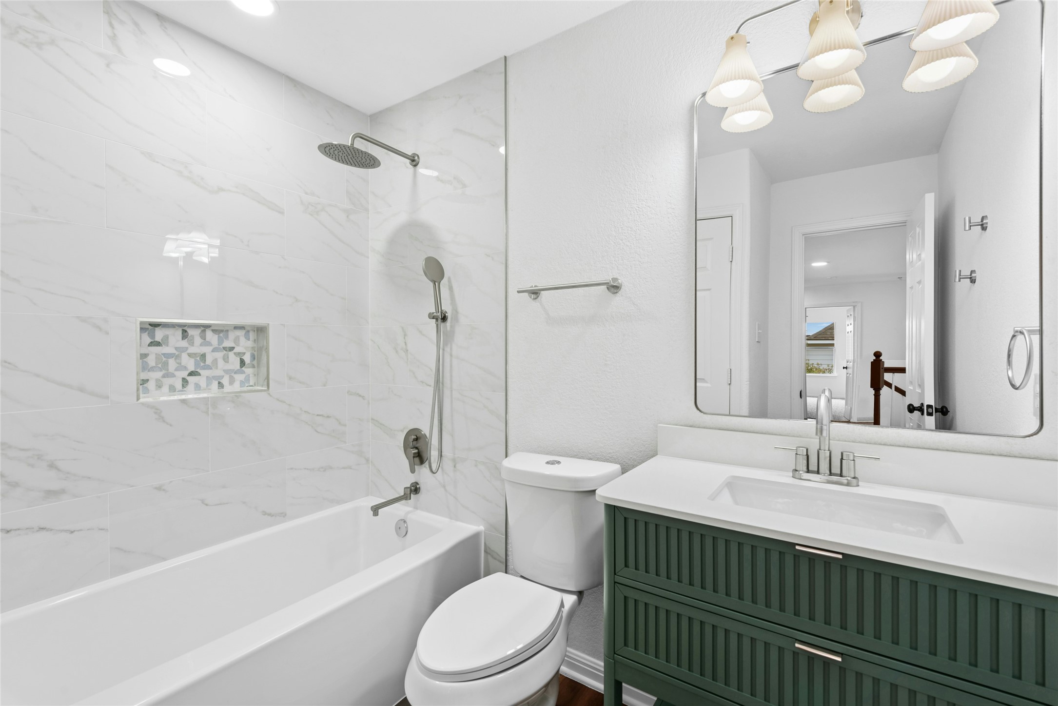 813 Caribou Ridge Trail Pflugerville, TX 78660 - Photo 37 of 39 a bathroom with a sink a toilet a mirror a bathtub and shower