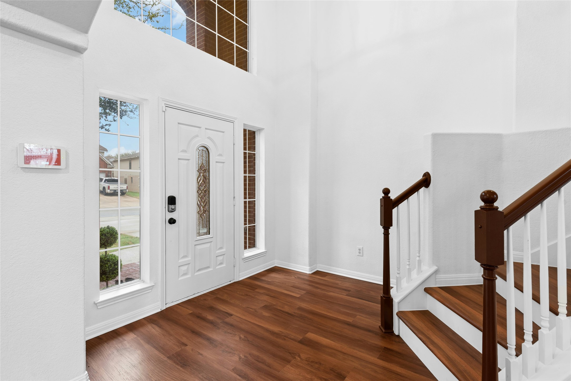 813 Caribou Ridge Trail Pflugerville, TX 78660 - Photo 4 of 39 Grand foyer entrance featuring soaring ceilings, a sweeping staircase, and warm luxury vinyl plank flooring that creates an elegant first impression.