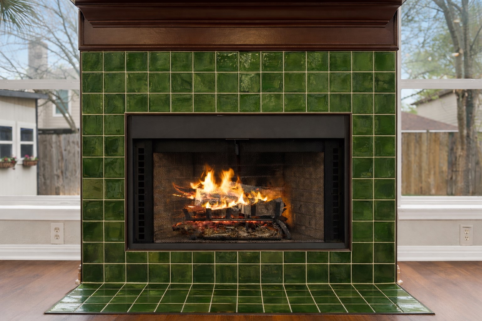 813 Caribou Ridge Trail Pflugerville, TX 78660 - Photo 9 of 39 A striking fireplace framed with rich artisan green tile creates a sophisticated focal point in the main living area, adding warmth, character, and timeless charm while complementing the home's natural light and elegant design.