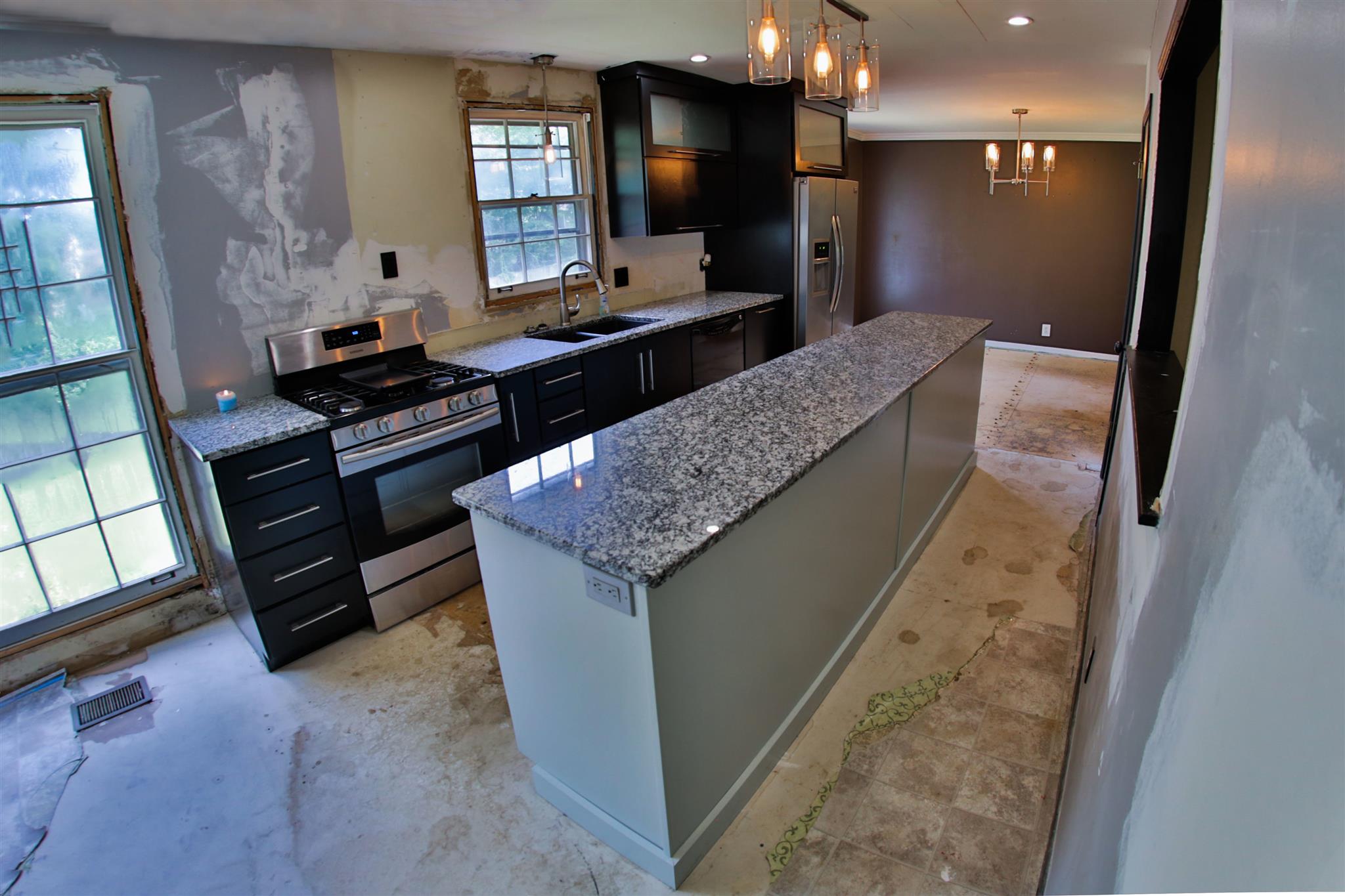 2949 Anderson Road Nashville, TN 37217 - Photo 3 of 29 a bathroom with a granite countertop sink a large mirror and a shower